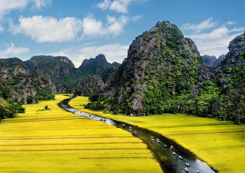 Boat tour through lush green river valley.