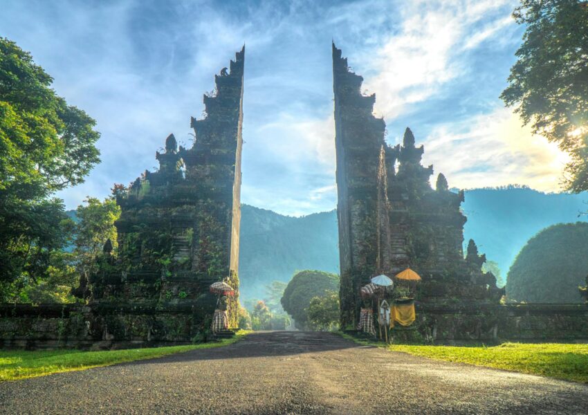 Traditional Candi Bentar split gateway standing tall against a scenic Balinese backdrop